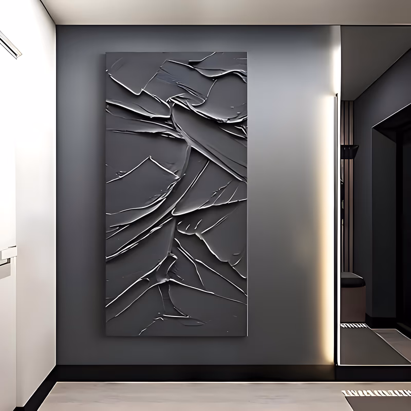 a tall vertical monochrome painting of overlapping black plaster sweeps laid at angles over the full canvas, their raised knife edges catching light in thin charcoal gray highlights