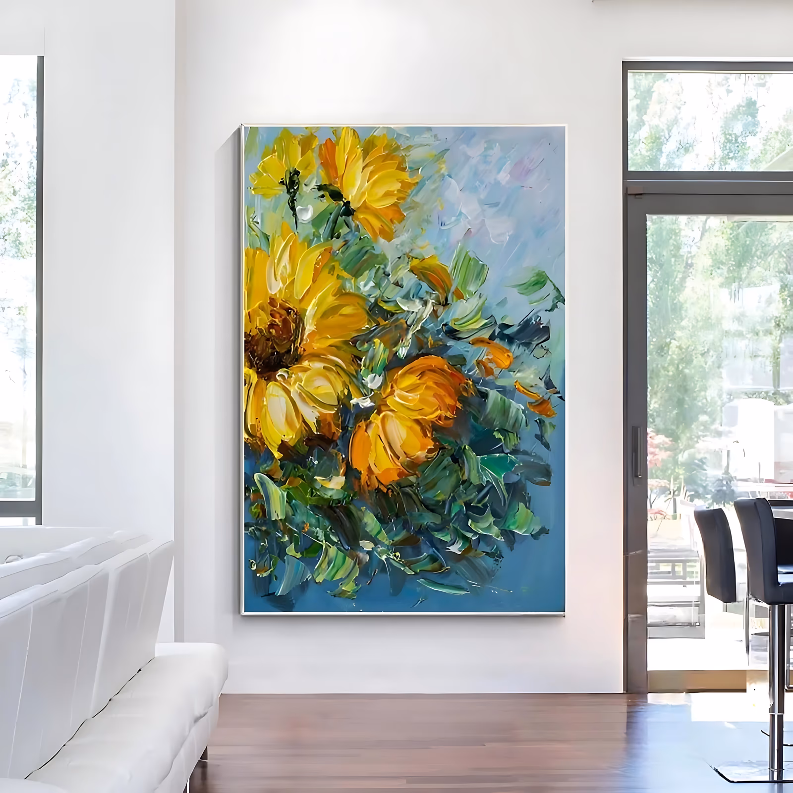 a large vertical palette-knife painting of golden yellow sunflowers with dark centers gathered at the left of the frame, green leaf strokes fanning out below, all on a soft blue and teal ground in thick impasto oil